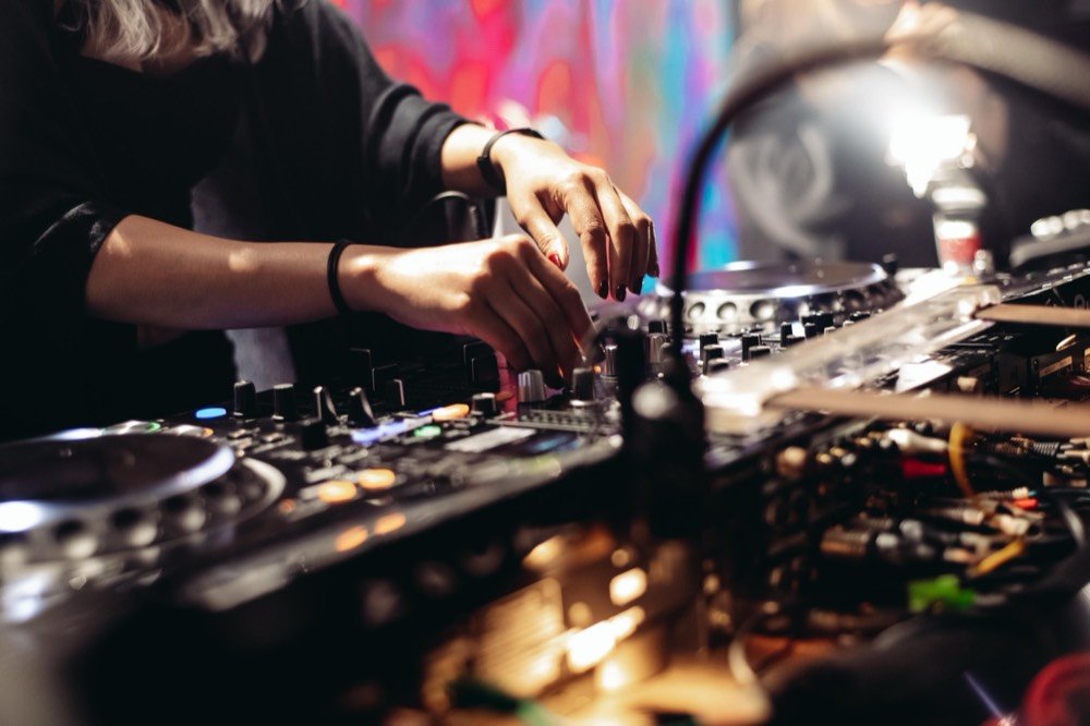 Zouk, Singapore — close on both hands working the mixer